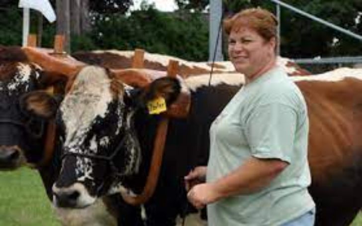 Brenda Grettenberger is on a cow farm.